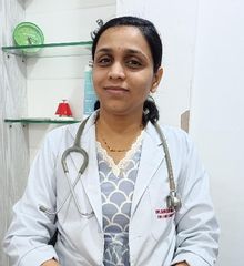 Dr. Shraddha Bihani wearing a stethoscope and a white coat, seated in a clinical setting with shelves in the background.